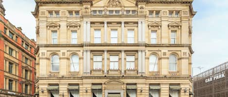 A historic building with classical architecture, featuring symmetrical windows and a central entrance.