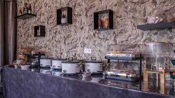 A buffet setup with multiple food stations, including a variety of dishes and beverages.