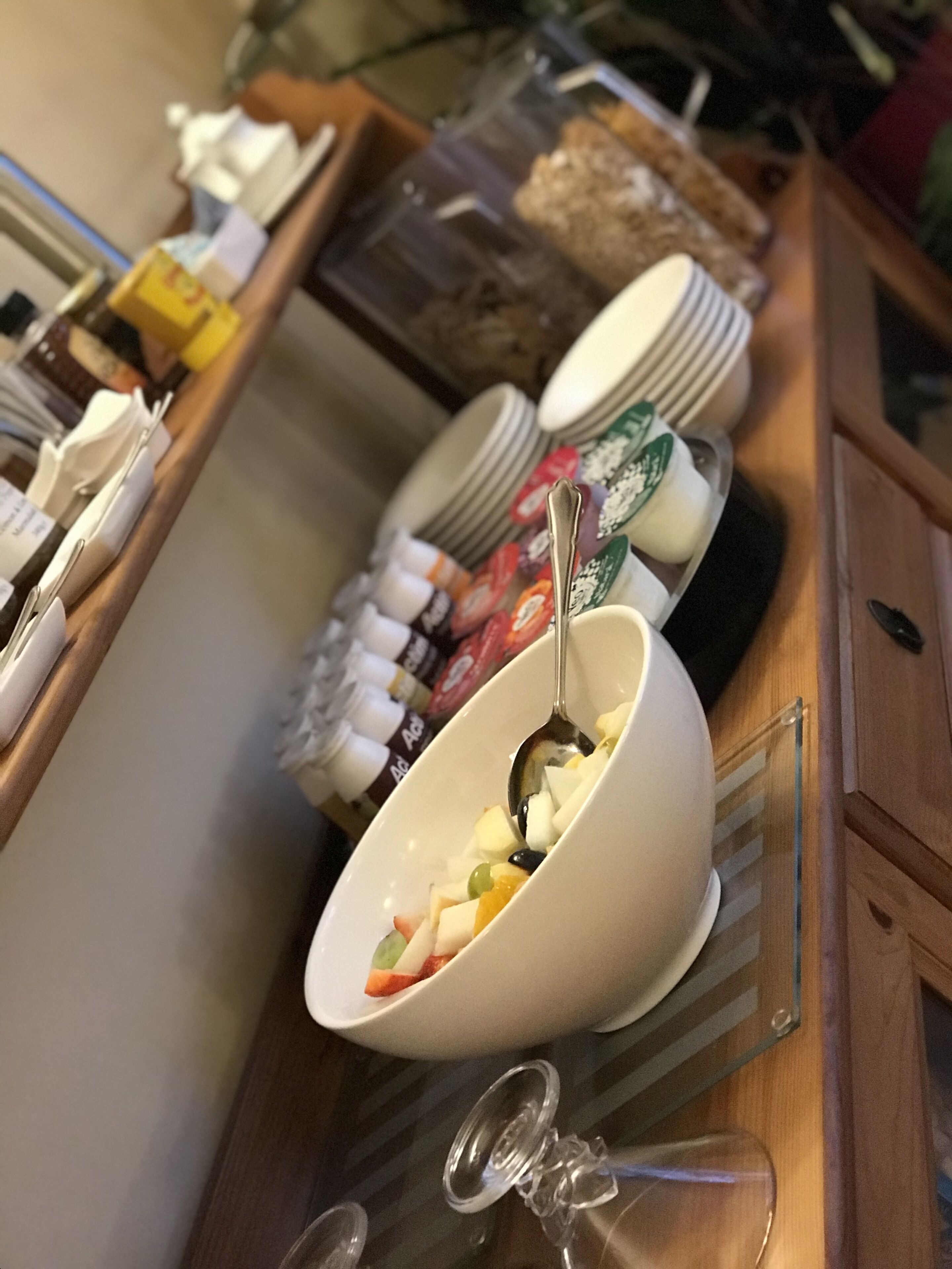 A buffet setup with various food items and condiments.