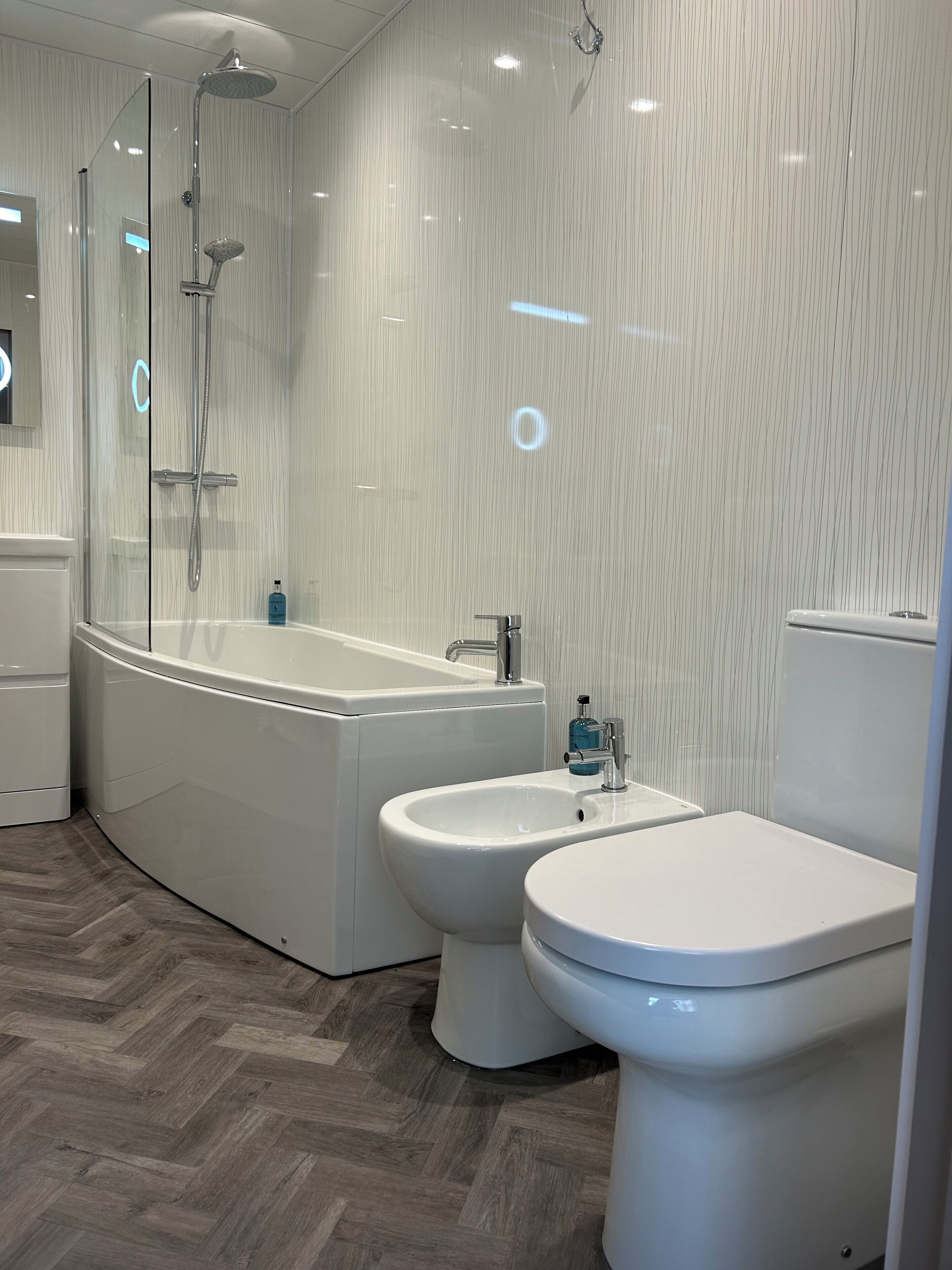 Un baño moderno con una bañera independiente, un bidé y un inodoro.