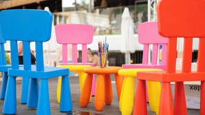 Colorful chairs and tables arranged outdoors, likely in a public or commercial setting. - Hotel Parasol by Dorobe (Torremolinos)