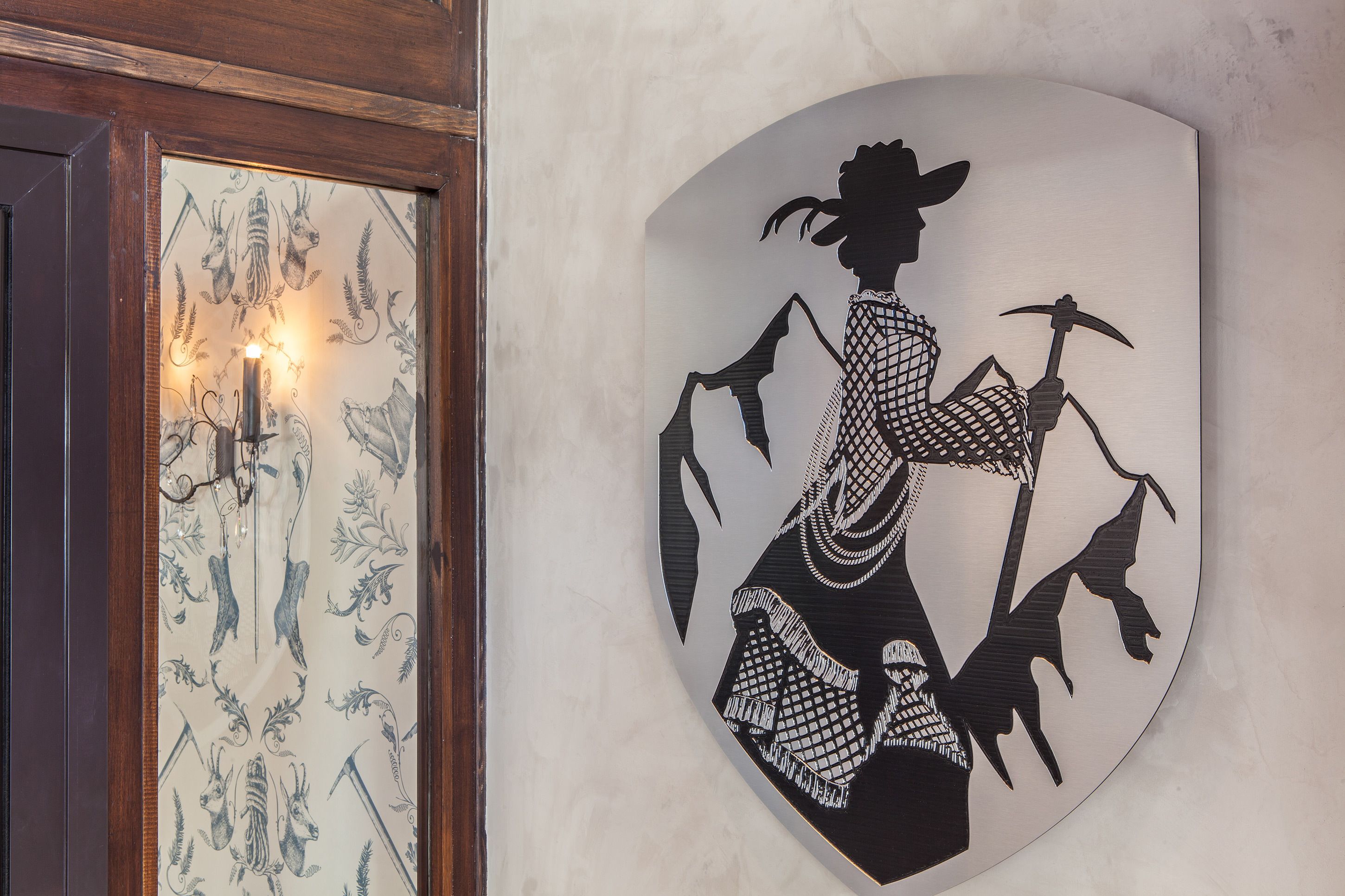 A wall-mounted shield with a silhouette of a person holding a pickaxe.