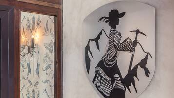 A wall-mounted shield with a silhouette of a person holding a pickaxe.