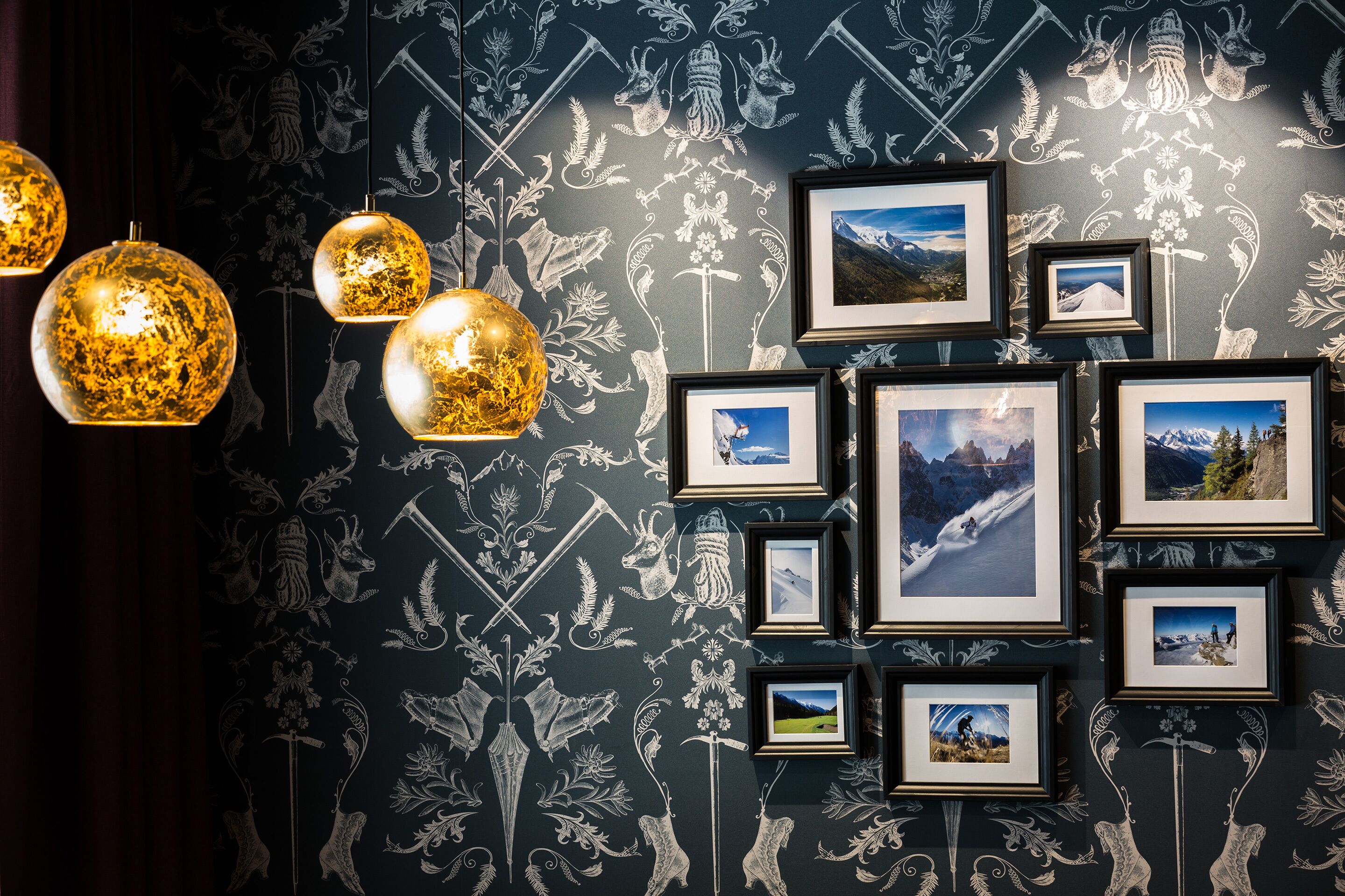 A wall with framed photographs and decorative wall art.