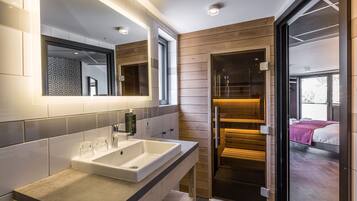 A modern bathroom with a large sink, two mirrors, and a wooden panel wall.
