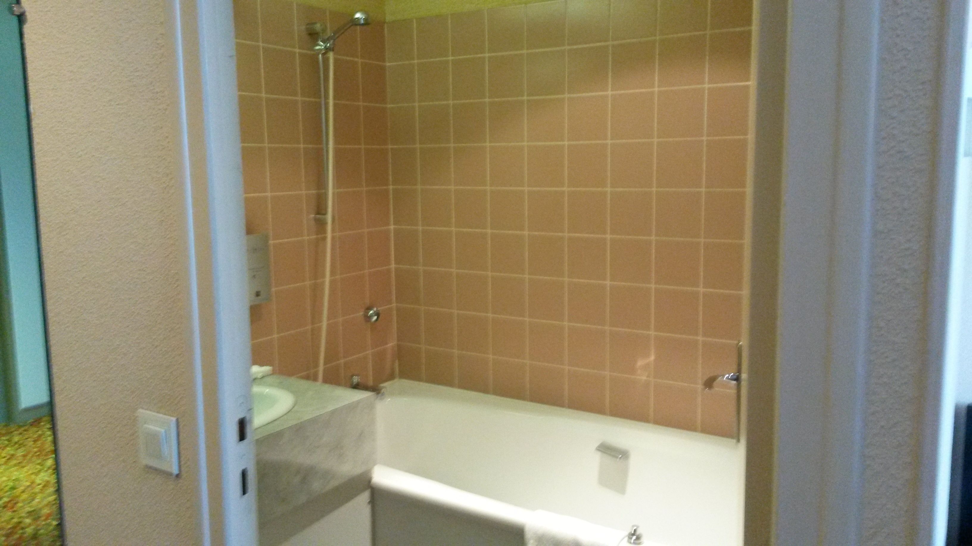 A bathroom with a shower, a sink, and a bathtub.