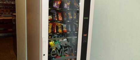 A vending machine stocked with snacks and drinks.