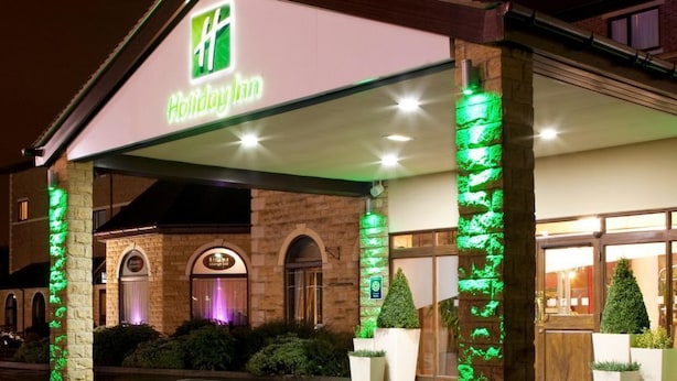 A Holiday Inn with a brick facade, a covered entrance, and green vertical lighting accents. - Holiday Inn Barnsley by IHG (Barnsley)