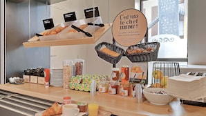 A breakfast buffet with croissants, bread, and various spreads. - B&B HOTEL LE MANS Centre (Le Mans)