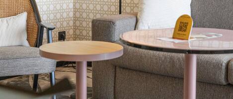 A seating area with a sofa, a chair, and a small round table.