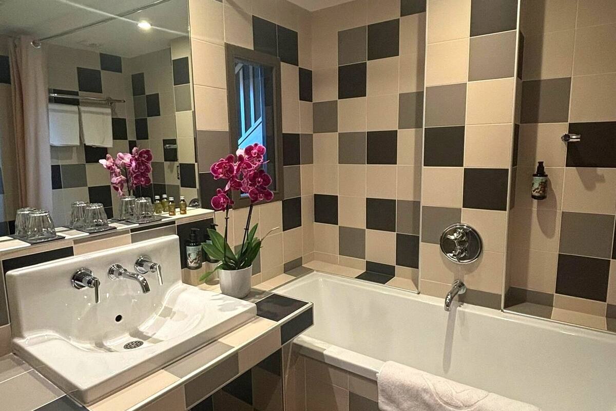 family duplex suite | bathroom | hair dryer, slippers, towels