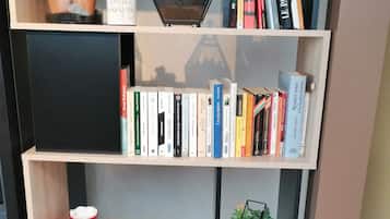 Une bibliothèque contenant des livres, des magazines et des objets décoratifs.