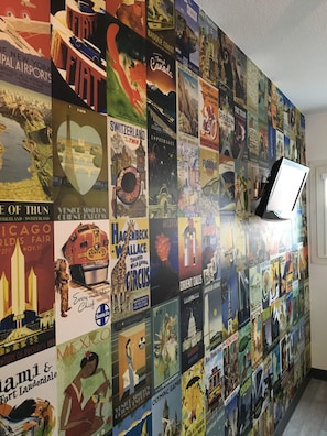Travel the world from the comfort of your space, surrounded by vintage travel posters showcasing iconic landmarks and cultural events.