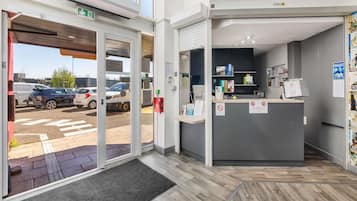 A reception area with a desk, computer, and various informational signs.