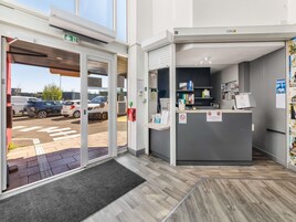 A reception area with a desk, computer, and various informational signs.