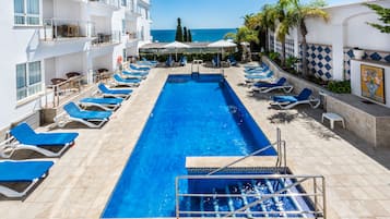 Indoor pool, outdoor pool, open 10 AM to 7 PM, pool umbrellas