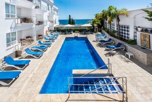 Indoor pool, outdoor pool, open 10 AM to 7 PM, pool umbrellas
