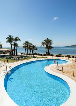Una piscina al aire libre, tumbonas