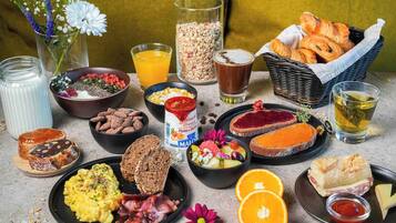 A breakfast spread with various foods and drinks.