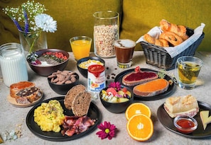 A breakfast spread with various foods and drinks.