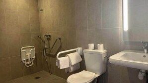 A bathroom with a toilet, sink, and shower area. - B&B HOTEL Amélie-les-Bains Centre (Amelie-les-Bains-Palalda)