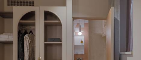 A room with a wooden ceiling, a wardrobe with a mirror, a sink, and a chessboard on a table.
