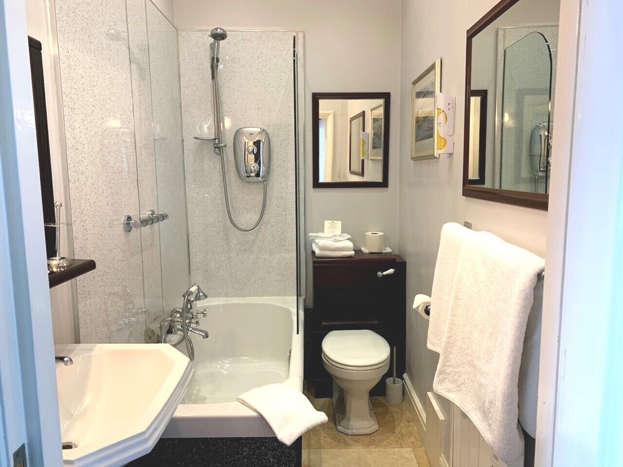 A bathroom with a shower, a bathtub, a toilet, and a sink.