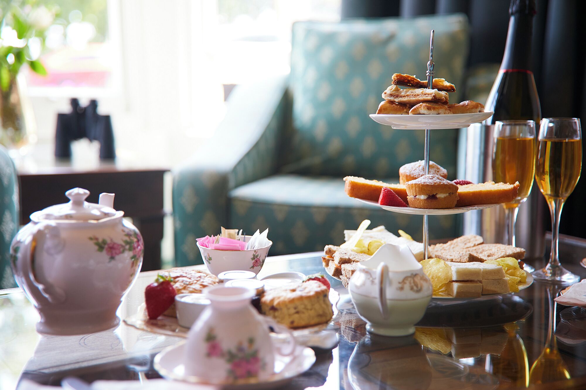 A tea service set with teacups, a sugar bowl, and a teapot on a table.