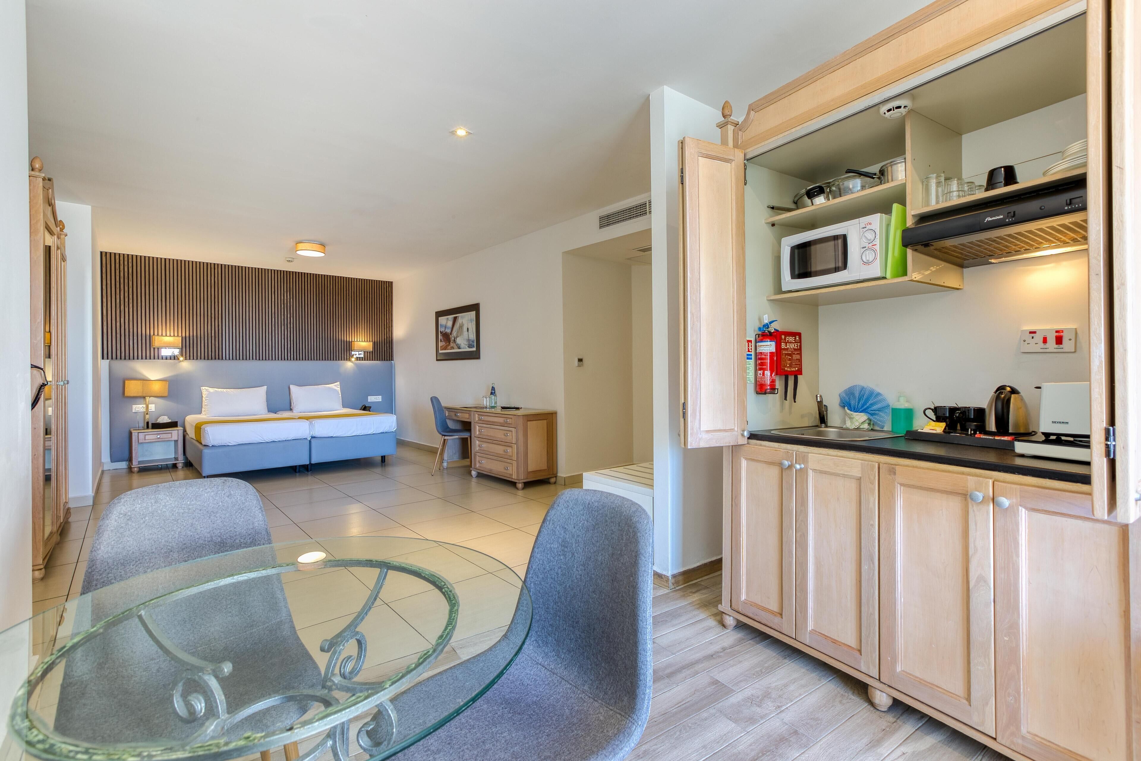 A modern kitchen with wooden cabinets, a microwave, and a coffee maker.