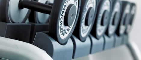 A set of dumbbells on a rack.