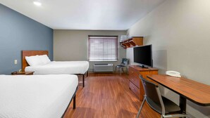 A hotel room with two beds, a desk, a TV, and a window with blinds. - Extended Stay America Select Suites - Lubbock - West (Lubbock)