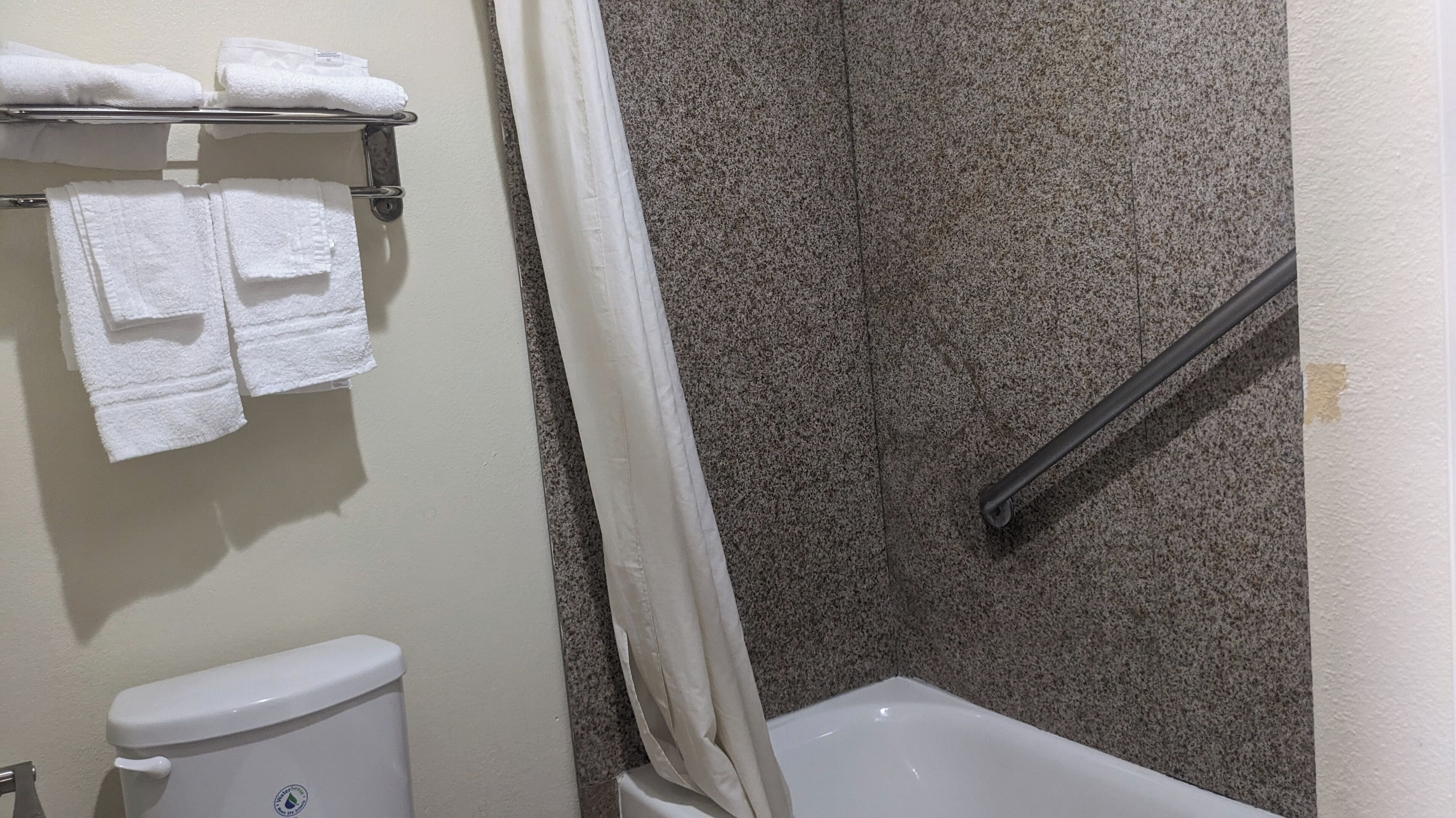 Bathtub, designer toiletries, hair dryer, towels