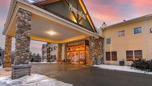 A hotel entrance with a stone facade, a covered entrance area, and a sign reading "Mountain Edge."