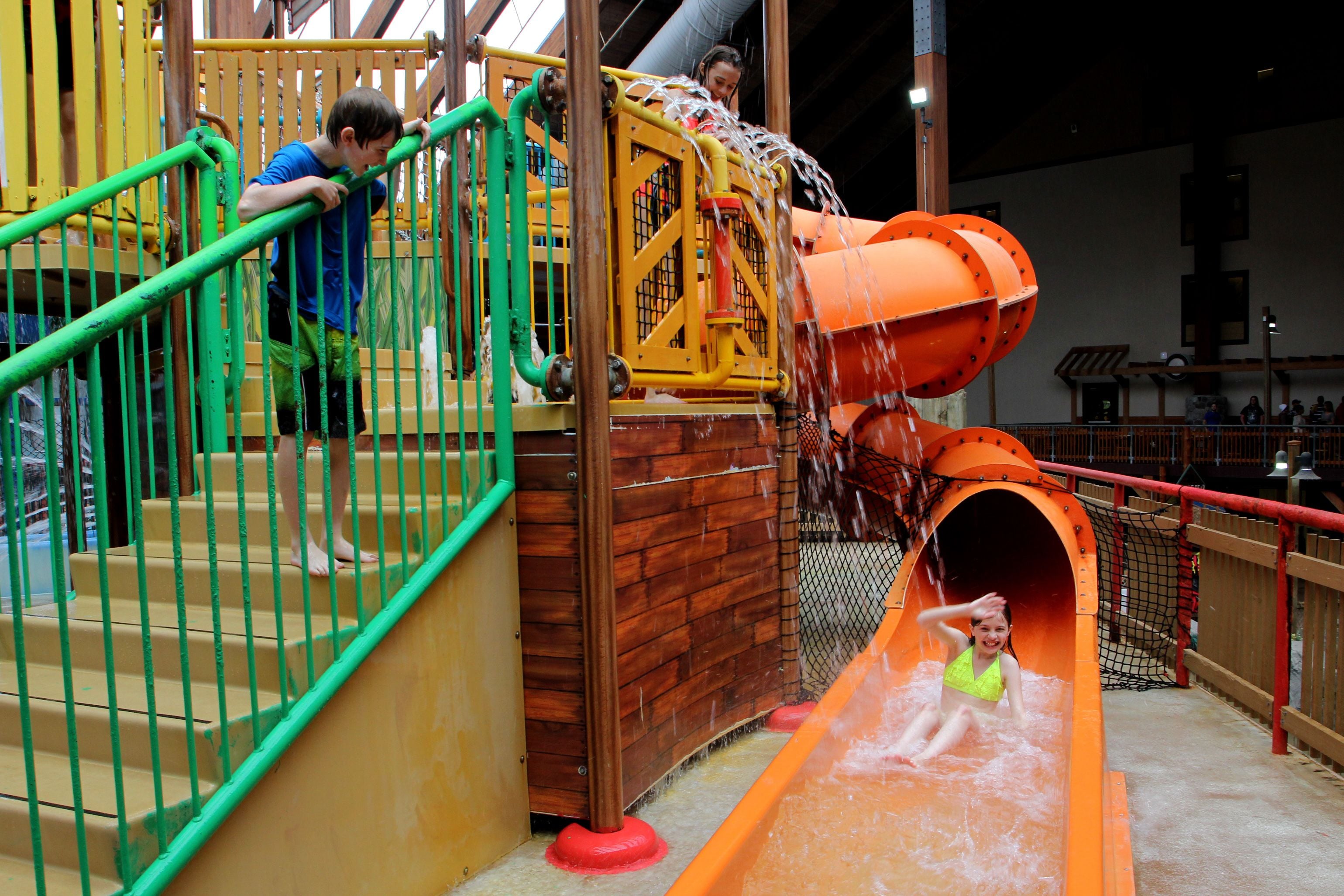 A water play area with a slide and stairs.