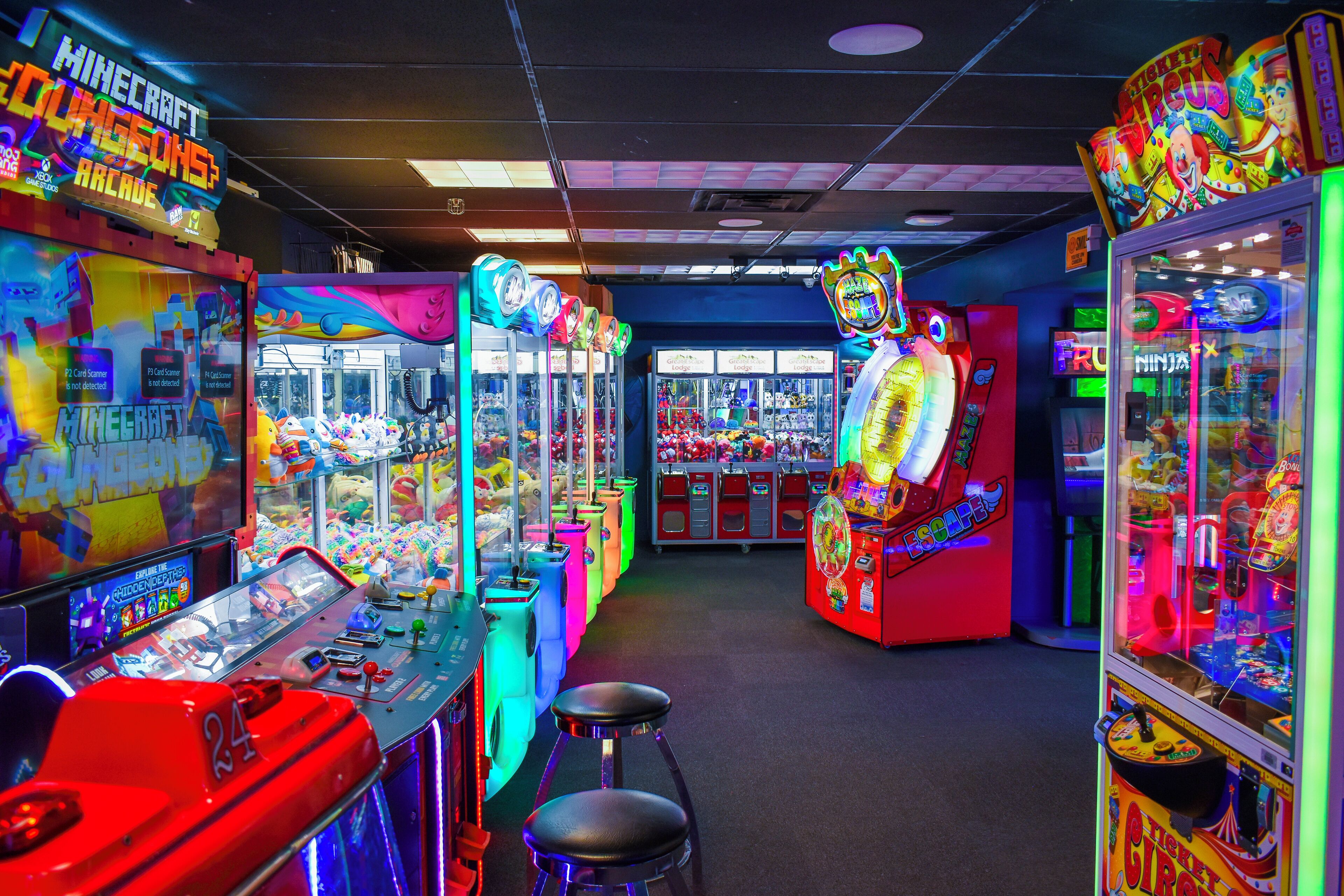 A brightly lit arcade with various gaming machines, including a prominent 'Minecraft' game.