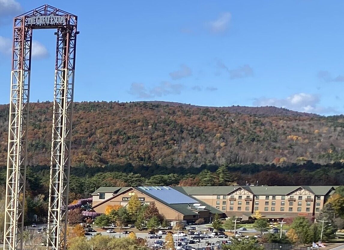 A hotel with a prominent tower structure labeled "The Great Escape" and a parking lot in front.