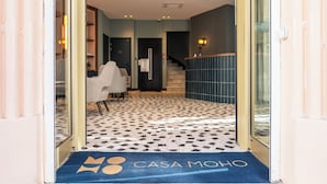 A hotel entrance with a patterned floor, a reception desk, and a staircase. - CASA MOHO - Juan-Les-Pins (Antibes)