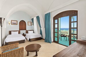 A hotel room with two beds, a balcony with a view, and a dining area. - Swissôtel Resort El Quseir (El Quseir)