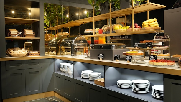 A buffet with various food items and a coffee station. - Hotel Urbani (Turin)