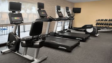 A gym with treadmills, ellipticals, and weight machines.