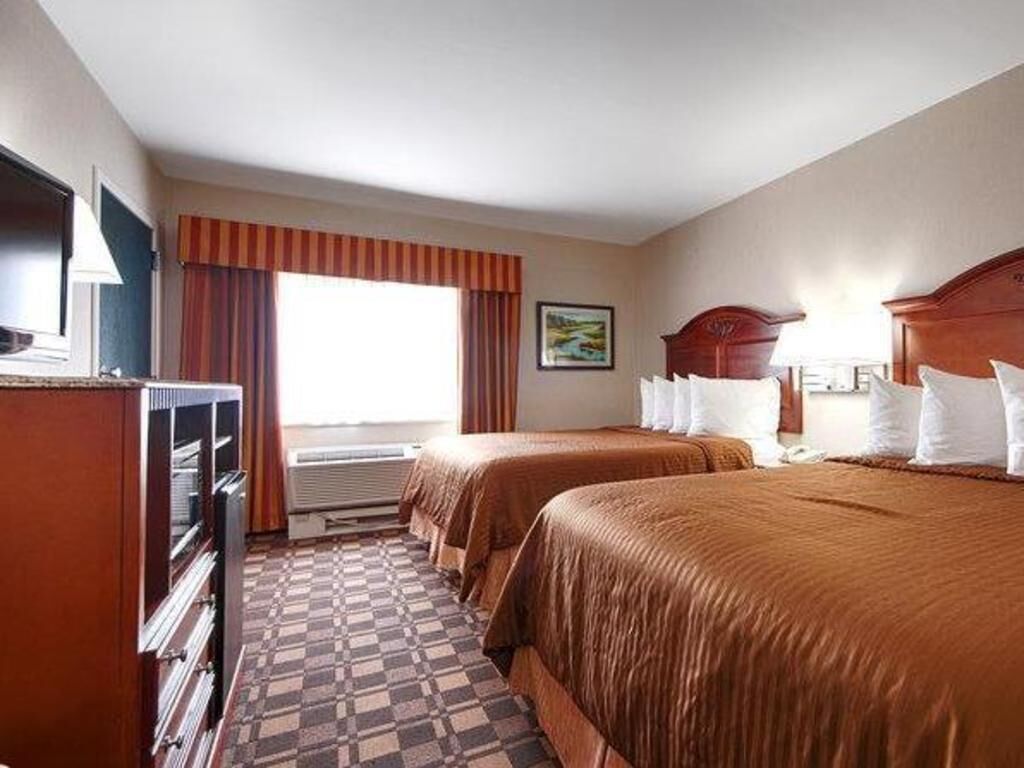 Premium bedding, pillowtop beds, laptop workspace, blackout drapes