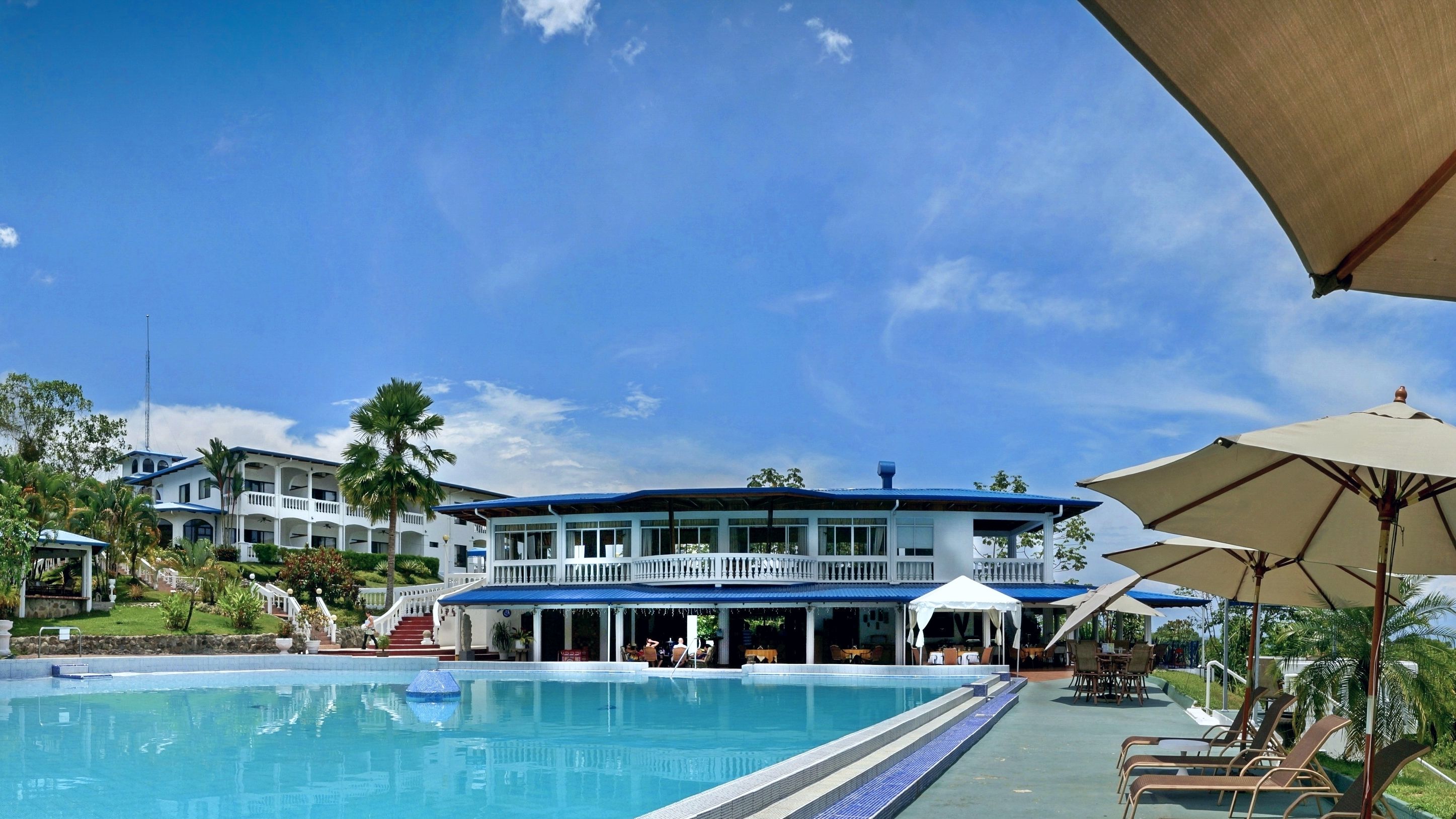 Un hôtel doté d’une piscine, d’un espace extérieur aménagé et d’une zone couverte.