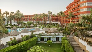A resort with multiple buildings, palm trees, and a swimming pool area. - Pyramisa Hotel Luxor (Luxor)