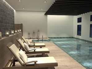 A modern indoor pool area with lounge chairs, a tiled floor, and a stone wall. - DoubleTree by Hilton Toluca (Toluca)