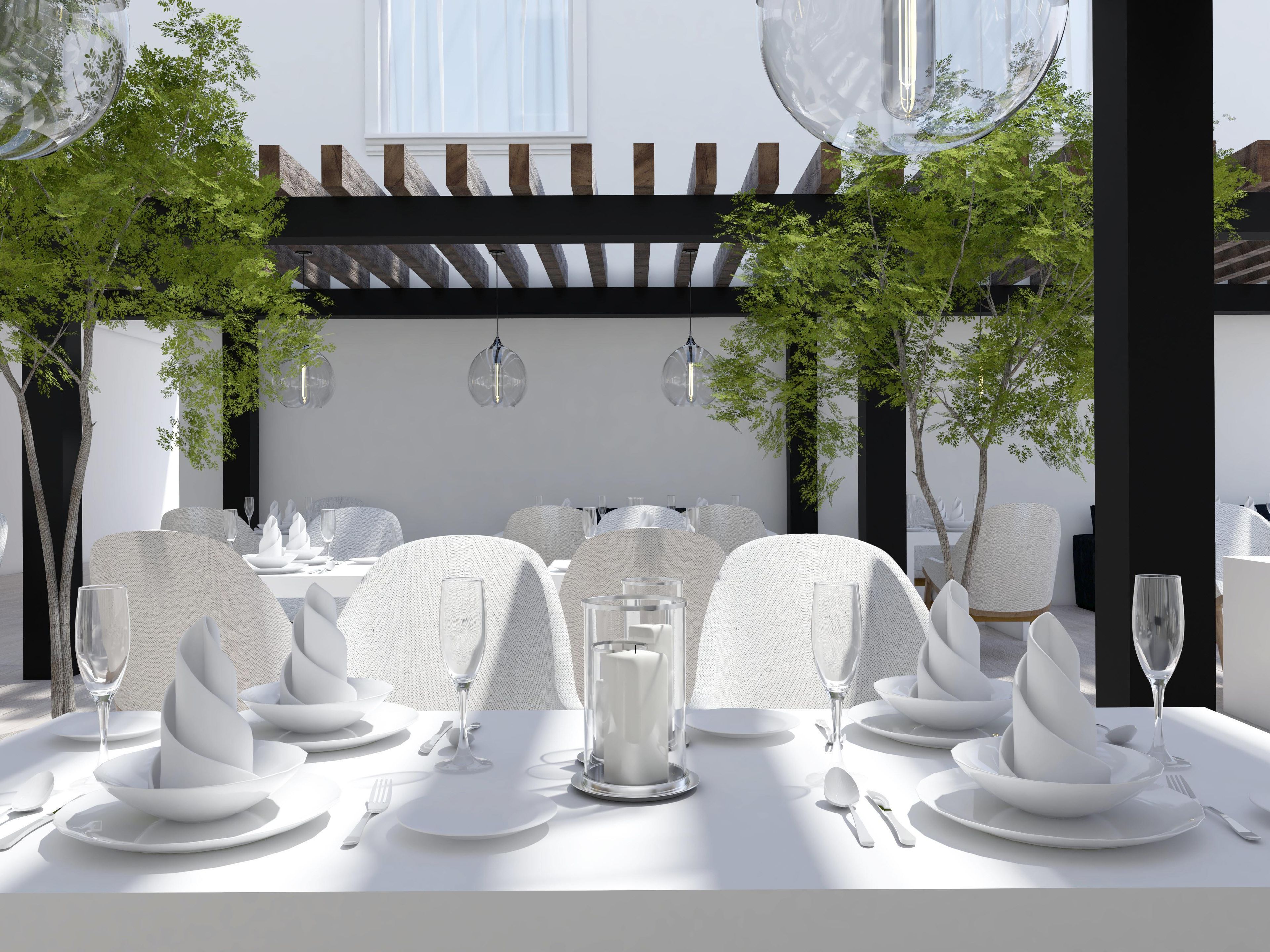 Un comedor con vajilla blanca, que incluye platos, vasos y cubiertos.