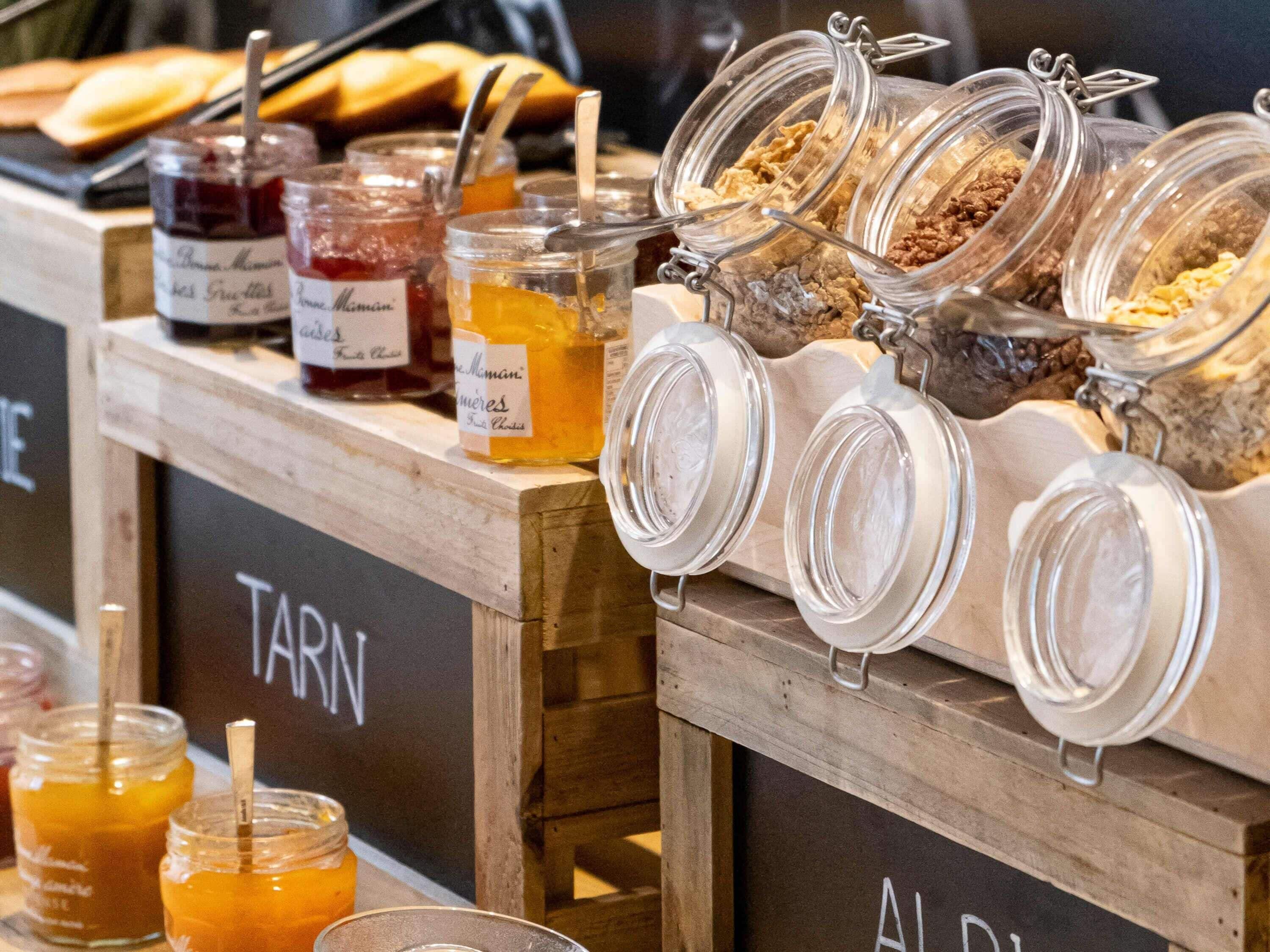 A breakfast buffet with various food items and condiments.