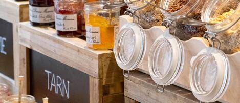 A breakfast buffet with various food items and condiments.