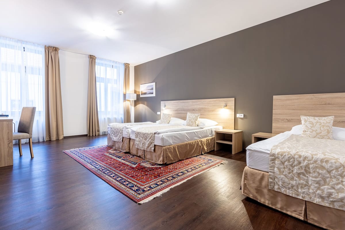 Una habitación de hotel con dos camas, un escritorio y una silla.