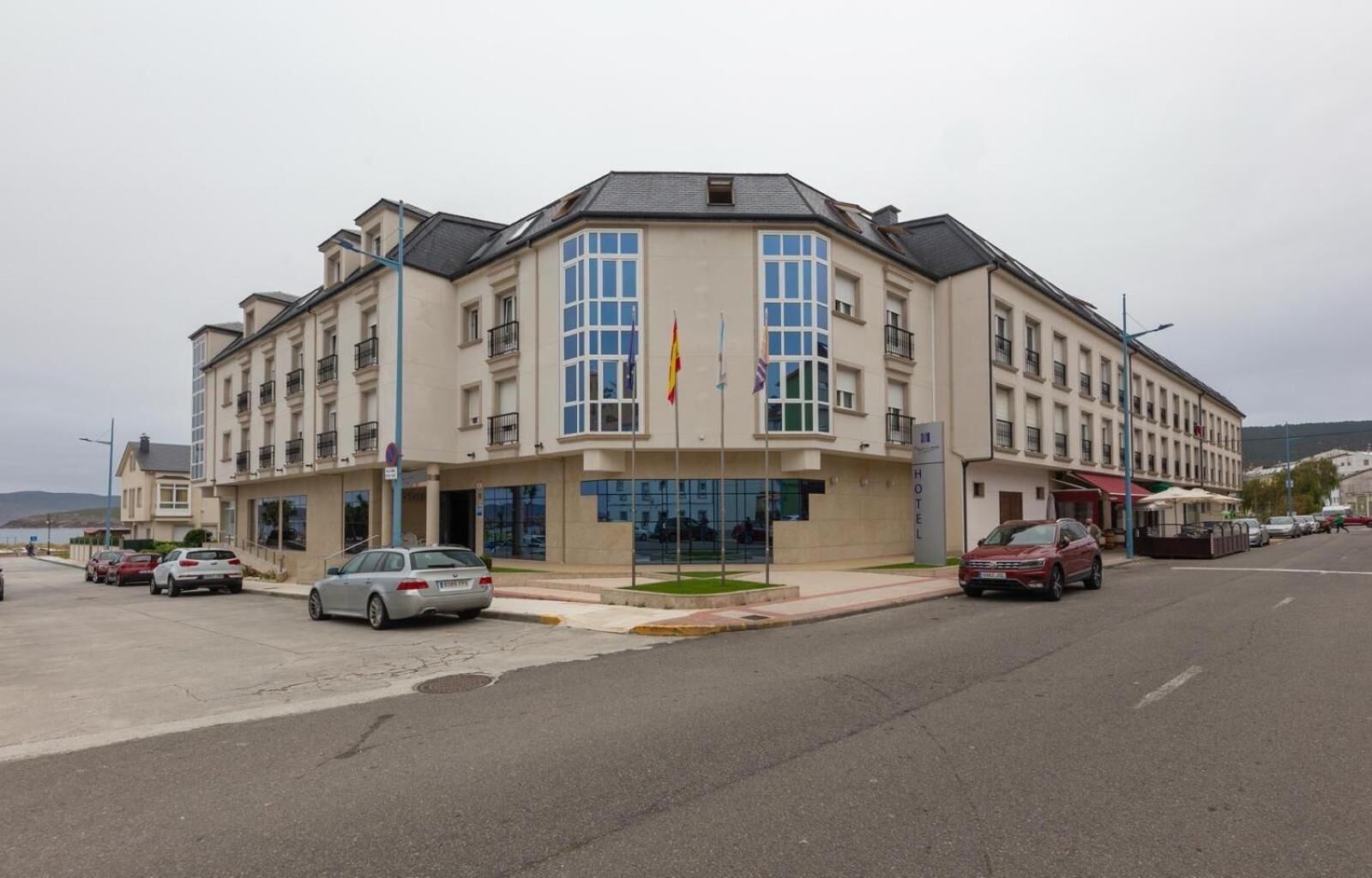 A hotel with a modern facade, multiple balconies, and a prominent entrance.