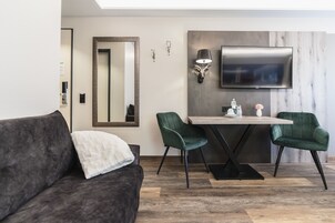 Premium Quadruple Room | Living area | Flat-screen TV